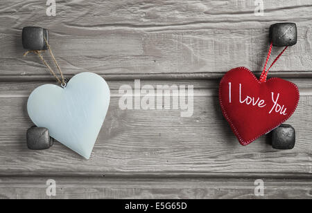 Two Wooden Hearts Placed On A Brown Wood Board. Stock Photo