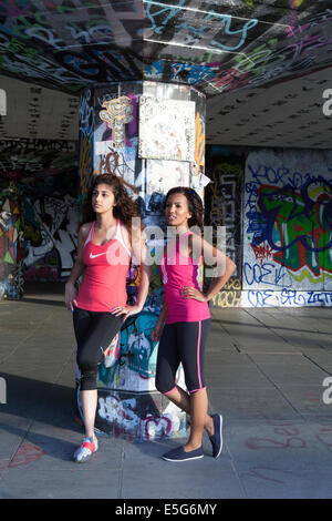 two fit Asian young women home training concept wearing sports top and  leggings Stock Photo - Alamy