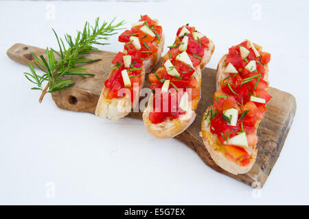 Ready to eat italian bruschetta with tomatoes and rosemary Stock Photo