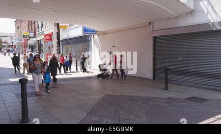 Taking advantage of the shade of a road bridge on a hot day in George Street Altrincham, Cheshire Stock Photo