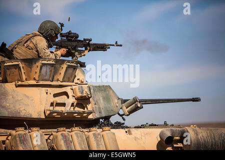 A U.S. Marine with Battalion Landing Team, 1st Battalion, 6th Marine Regiment, 22nd Marine Expeditionary Unit (MEU) shoots at t Stock Photo