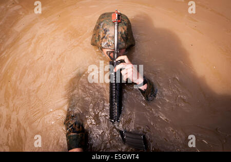 A U.S. Marine Corps candidate assigned to Lima Company, Officer Candidates School, back crawls through an obstacle while naviga Stock Photo