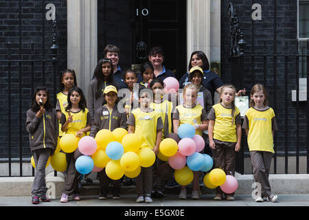 London, UK. 31 July 2014. Brownies from all over the country today visited Prime Minister David Cameron at Downing Street to celebrate the centenary of the Brownies. A Brownies group from Bradford/West Yorkshire is leaving No. 10 Downing Street. Credit:  Nick Savage/Alamy Live News Stock Photo