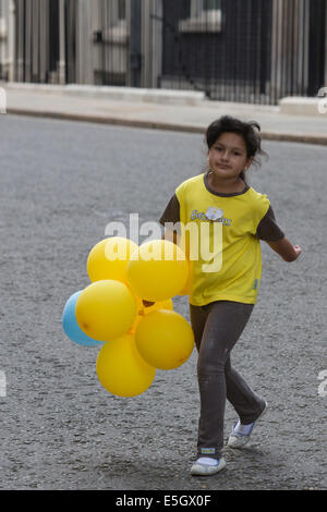 London, UK. 31 July 2014. Brownies from all over the country today visited Prime Minister David Cameron at Downing Street to celebrate the centenary of the Brownies. A Brownie from Bradford/West Yorkshire is leaving No. 10 Downing Street. Credit:  Nick Savage/Alamy Live News Stock Photo