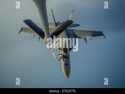 A U.S. Navy F/A-18E Super Hornet aircraft with Strike Fighter Squadron (VFA) 195 conducts an aerial refueling with an Air Force Stock Photo