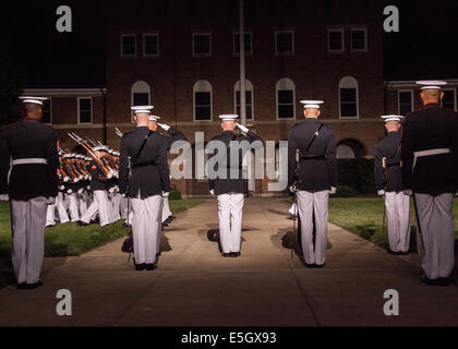 U.S. Marines stand and salute the pass and review during the Evening Parade Ceremony at Marine Barracks Washington, D.C., June Stock Photo