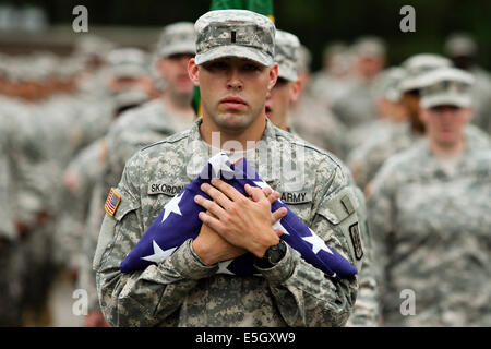 A U.S. Soldier assigned to the Army Reserve 423rd Military Police (MP) Company holds an American flag, accompanied by his fello Stock Photo