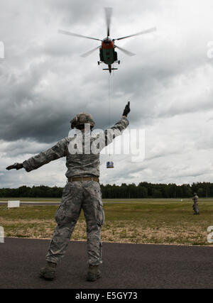 U.S. Air Force Staff Sgt. Timothy Kennedy, with the 435th Security Forces Squadron, marshals a Latvian Mi-8 helicopter June 17, Stock Photo