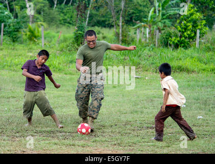 U.S. Marine Corps Lance Cpl. Esgar A. Castro plays soccer with students at Bethel Seventh-day Adventist School in Punta Gorda, Stock Photo