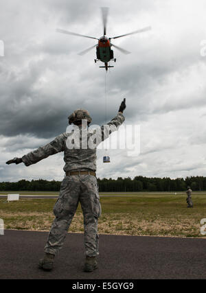 U.S. Air Force Staff Sgt. Timothy Kennedy, with the 435th Security Forces Squadron, marshals a Latvian Mi-8 helicopter during s Stock Photo