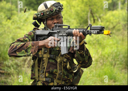 A Kenyan soldier equipped with Deployable Instrumentation Systems Europe gear fires blanks at the Joint Multinational Training Stock Photo