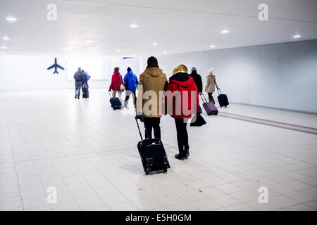 Passengers with hand luggage travelling from Berlin's Central station to Schonefeld airport (flughafen) Stock Photo