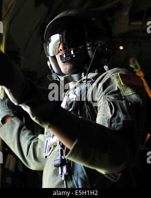 U.S. Air Force Airman 1st Class Ralph Colas, a loadmaster with the 37th Airlift Squadron, waits for the signal to allow U.S. So Stock Photo