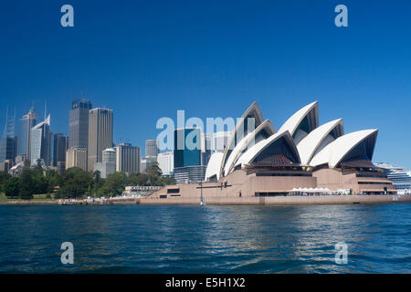 Sydney Opera House and skyscrapers of CBD Central Business District seen from ferry on harbour Sydney New South Wales NSW Austra Stock Photo