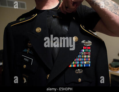 Dallas displays his Army dress uniform, complete with Combat Action Badge, Bronze Star, and Purple Heart. Stock Photo