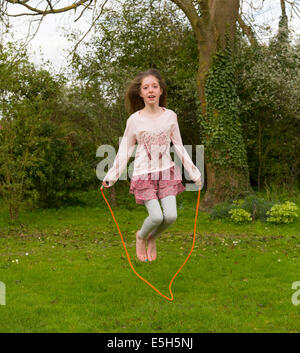young girl using skipping rope Stock Photo