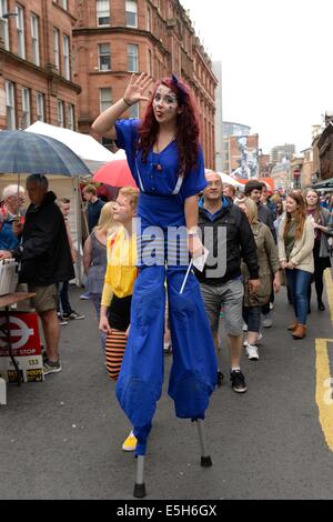 A street theatre girl on stilts at the Merchant city festival in Glasgow 2014