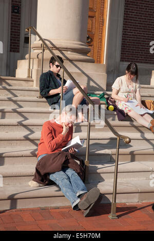 Students and visitors sit on the steps of Chapin Hall, Williams College in Williamstown, MA on a warm spring afternoon. Stock Photo
