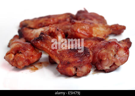 Spicy grilled hot wings isolated on white.