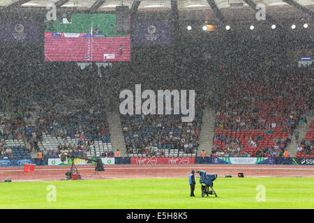 Hampden Park, Glasgow, Scotland, UK, Thursday, 31st July, 2014. A heavy rain shower at Hampden Park during Track and Field Competitions at the Glasgow 2014 Commonwealth Games Stock Photo