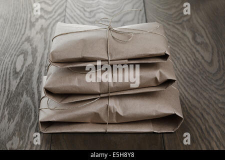 vintage style parcels wrapped with rope, on old oak table Stock Photo