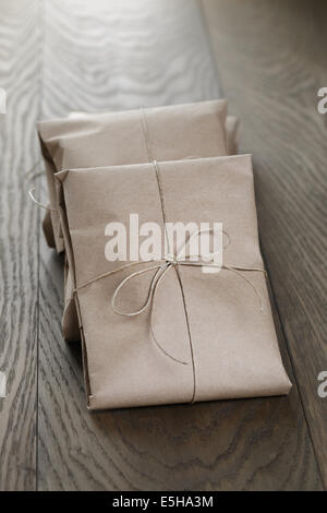 vintage style parcels wrapped with rope, on old oak table Stock Photo