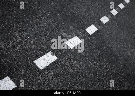 Dark asphalt road background with striped dividing marking line Stock Photo