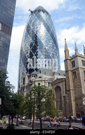 London, UK, 31 July 2014, The Norman Foster designed tower at 30 St Mary Axe in the heart of London's finincial area, nicknamed The Gherkin for its distinctive  shape, was put into bankruptcy protection last year. Deloitte Real Estate and Savills expect interest in the building to come from all over the world. The building is expected to sell for over £650 million. Stock Photo