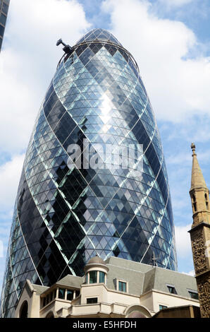 London, UK, 31 July 2014, The Norman Foster designed tower at 30 St Mary Axe in the heart of London's finincial area, nicknamed The Gherkin for its distinctive  shape, was put into bankruptcy protection last year. Deloitte Real Estate and Savills expect interest in the building to come from all over the world. The building is expected to sell for over £650 million. Stock Photo