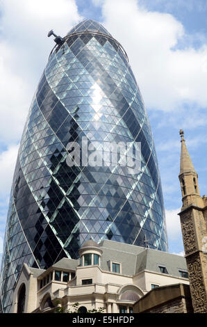 London, UK, 31 July 2014, The Norman Foster designed tower at 30 St Mary Axe in the heart of London's finincial area, nicknamed The Gherkin for its distinctive  shape, was put into bankruptcy protection last year. Deloitte Real Estate and Savills expect interest in the building to come from all over the world. The building is expected to sell for over £650 million. Stock Photo