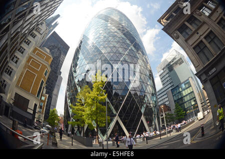 London, UK, 31 July 2014, The Norman Foster designed tower at 30 St Mary Axe in the heart of London's finincial area, nicknamed The Gherkin for its distinctive  shape, was put into bankruptcy protection last year. Deloitte Real Estate and Savills expect interest in the building to come from all over the world. The building is expected to sell for over £650 million. Stock Photo