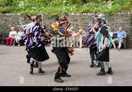 Morris dancers with blackened faces performing on the harbour at Ilfracombe north Devon England UK Black faces are a disguise Stock Photo