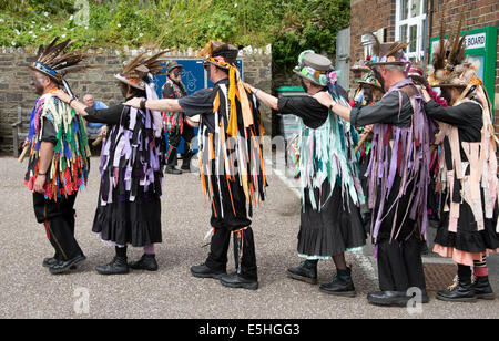 Morris dancers with blackened faces performing on the harbour at Ilfracombe north Devon England UK Black faces are a disguise Stock Photo