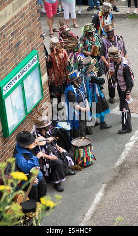 Morris dancers with blackened faces performing on the harbour at Ilfracombe north Devon England UK Black faces are a disguise Stock Photo