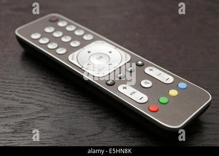 Remote control on a black wooden table Stock Photo
