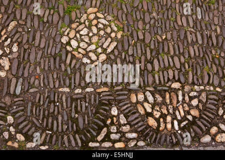 UK, England, Somerset, Nether Stowey, Lime Street, pebbles laid on edge in pattern to form cobbled pavement Stock Photo