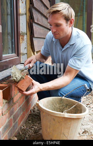 Construction Worker Laying Bricks Stock Photo