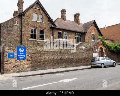 Newland House, Kingston & District Community NHS trust, exterior of old brick building and arched entrance - Twickenham, London Stock Photo