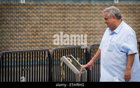 A visitor at the National World War II Memorial reads about the symbolism of the wall of stars, June 19, 2014 in Washington D.C Stock Photo