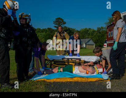 Local fire and EMS units package the patient for transport, June, 16 2014 in Baltimore Md. The Maryland Aviation command provid Stock Photo