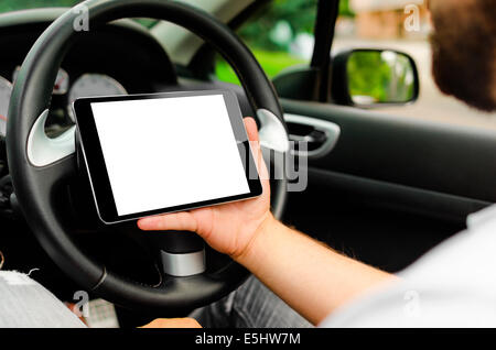 The man in the car, with the Tablet PC in hands Stock Photo