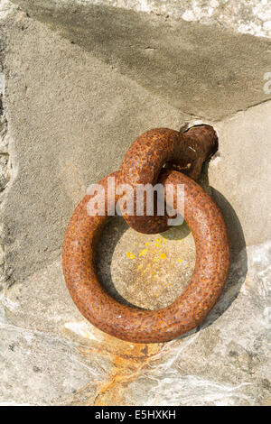 Iron ring set in concrete, old and rusty. Close up. Stock Photo