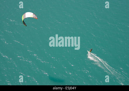 AERIAL VIEW. Kitesurfer on Lake Serre-Ponçon. Crots, Durance Valley, Hautes-Alpes, France. Stock Photo