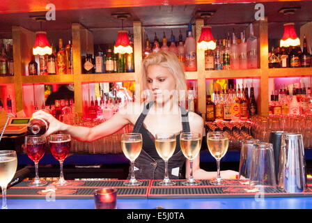 Young barmaid serving wine, London, England, UK Stock Photo