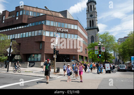 Pedestrians crossing the street in front of the main pavilion of the University of Quebec in Montreal (UQAM). Stock Photo