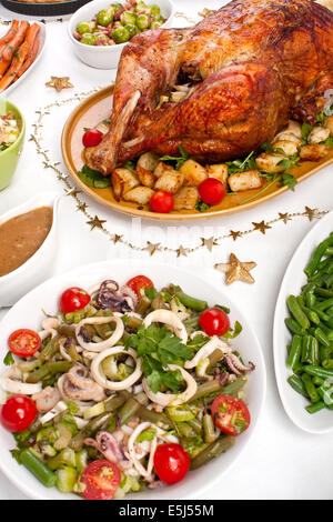 Christmas Decorated Dinner Table with Roasted Stuffed Turkey Stock Photo