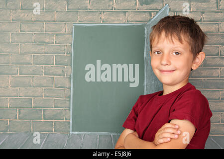 Education idea, the schoolboy before the open door represented on a chalkboard Stock Photo