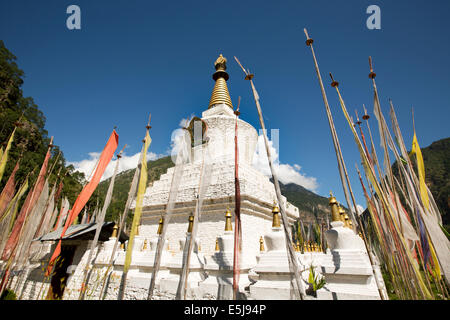 Eastern Bhutan, Lhuentse Valley Autsho, white Tibetan style brick built chorten surrounded by prayer flags Stock Photo