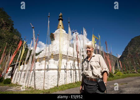 Eastern Bhutan, Lhuentse Valley Autsho, senior western tourist visiting Tibetan style chorten, Stock Photo