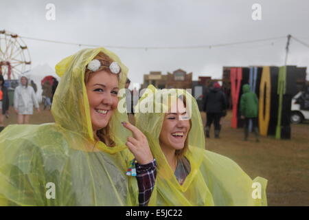Peak District, Derbyshire, UK. 2 August 2014. Music fans brave torrential rain on the second day of the Y Not Festival at Pikehall in the Peak District National Park. Billing as the ‘Small, Fresh and Loud' music festival, Y Not runs until 3 August 2014. Weather conditions are forecast to improve tomorrow. Credit:  Deborah Vernon/Alamy Live News Stock Photo